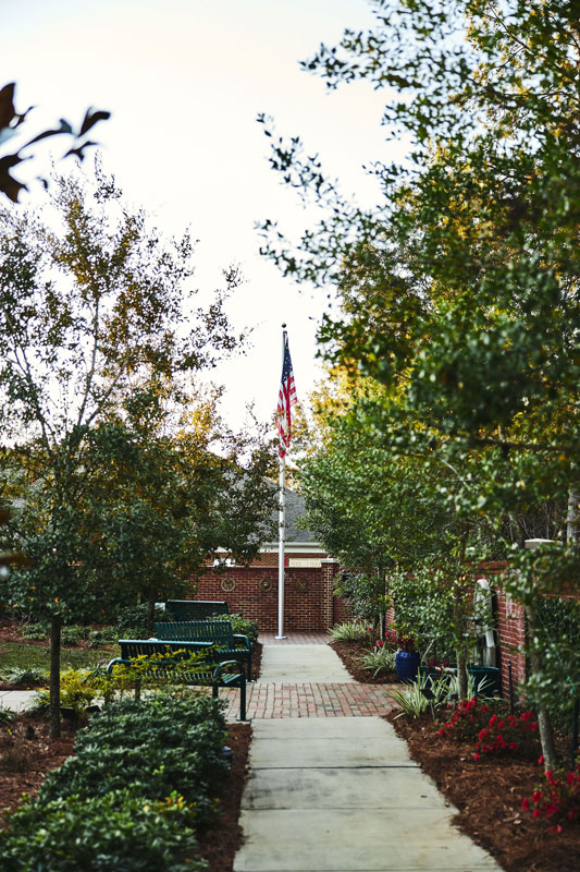 American flag on a pole in a garden