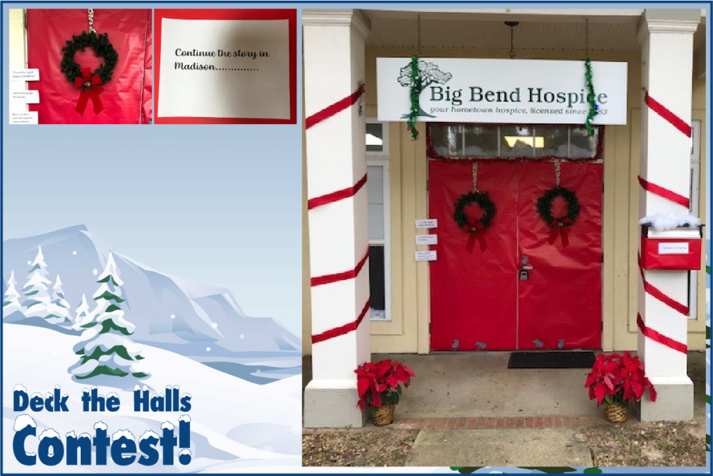 Double doors into hospice branch wrapped in red paper with evergreen wreaths on them.