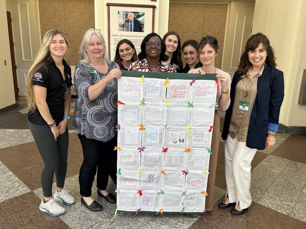 FSU College of Medicine Dean, Alma Littles in the center along with the FSU Dance Marathon student leadership representatives, Pam Mezzina, Jennifer Harris, and Dena Strickland. 