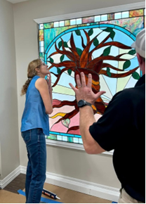 Ruth Nicken inspecting the installation of the stained-glass window