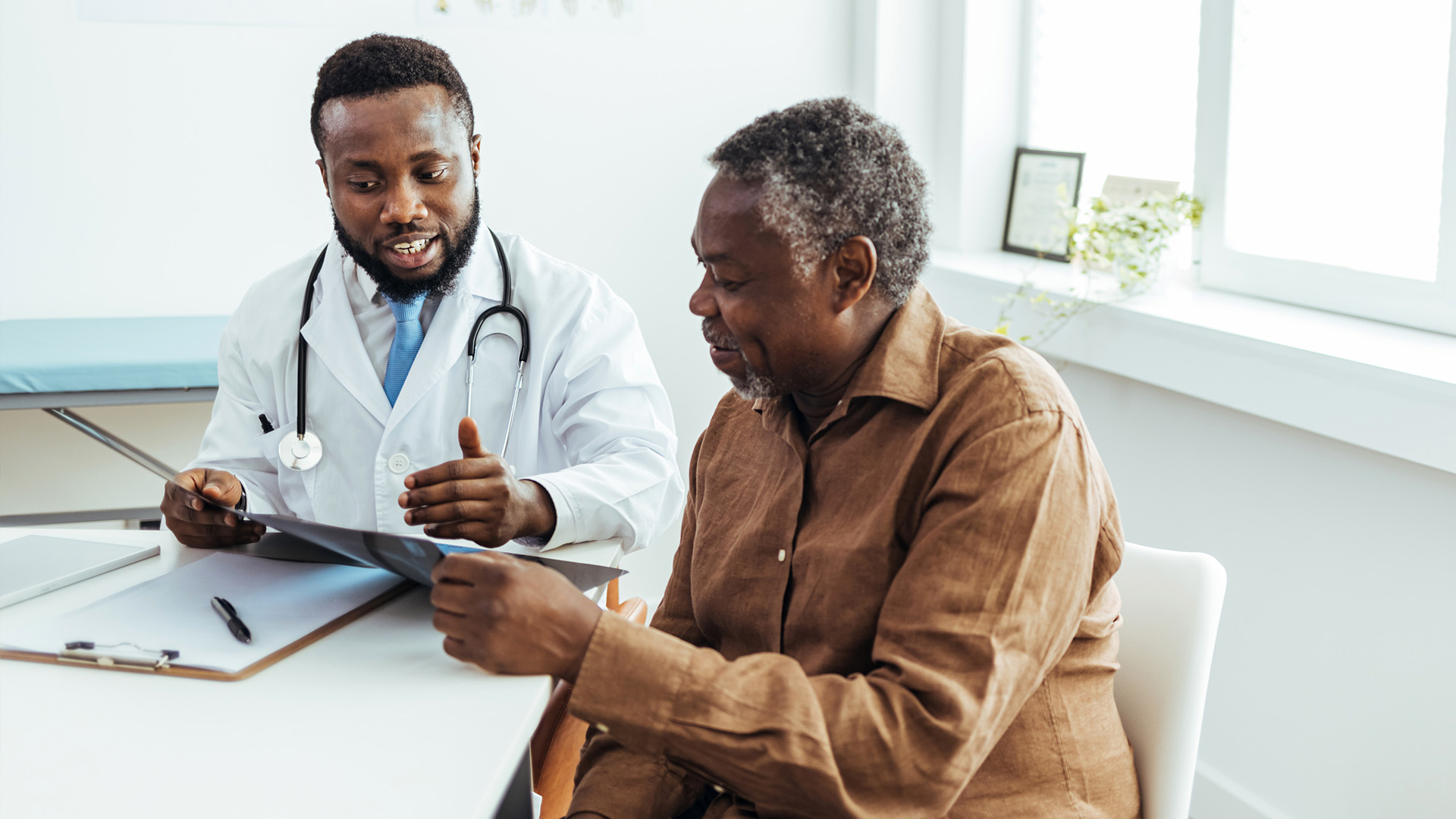 CNA holding hand of patient